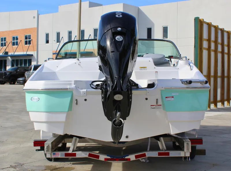 Slide: The Image of 2024 NauticStar DC Deck boat on trailer, rear view with outboard motor. - 3