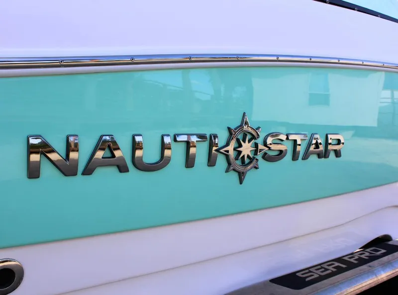 Slide: The Image of 2024 NauticStar DC Deck boat logo on turquoise and white hull. - 4