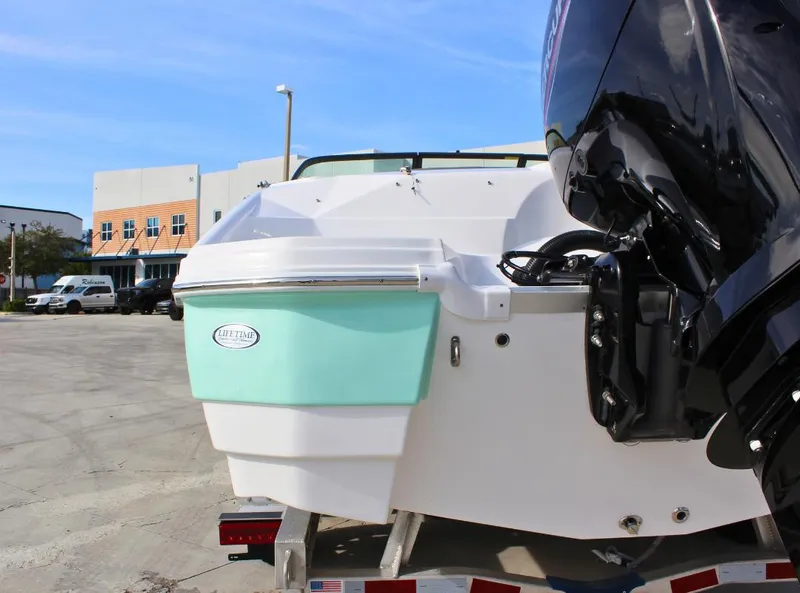 Slide: The Image of 2024 NauticStar DC Deck boat on trailer, rear view with outboard motor. - 5