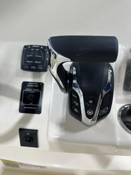 Slide: The Image of Close-up of 2025 Grady-White Fisherman 236 boat controls and throttle. - 11