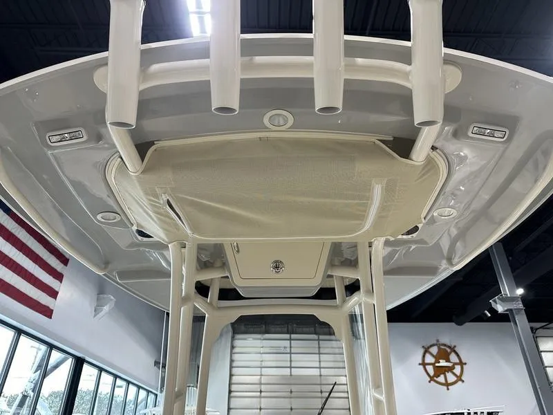 Slide: The Image of 2025 Grady-White Fisherman 236 boat, interior view with rod holders and American flag. - 13