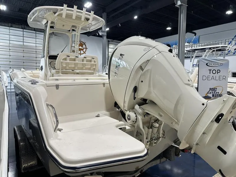 Slide: The Image of 2025 Grady-White Fisherman 236 boat displayed in showroom with powerful outboard motor. - 5