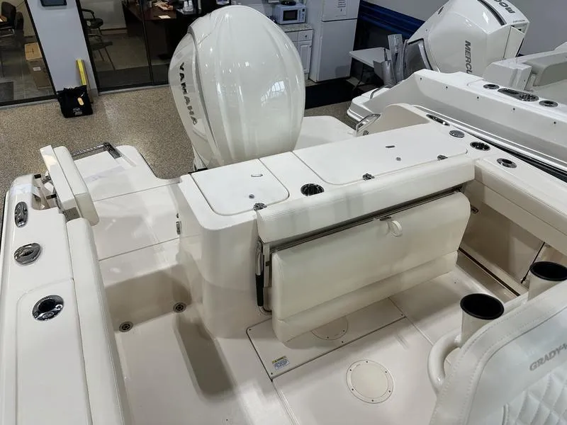 Slide: The Image of 2025 Grady-White Fisherman 236 boat interior with Yamaha engine, white seating, and storage compartments. - 8