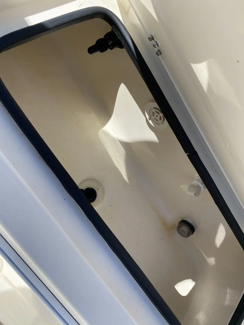 Slide: The Image of Open storage compartment in 2013 ShearWater 25LTZ boat. - 11