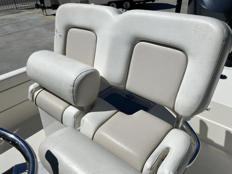 Slide: The Image of White leather seating on 2013 ShearWater 25LTZ boat, showing wear and tear. - 13