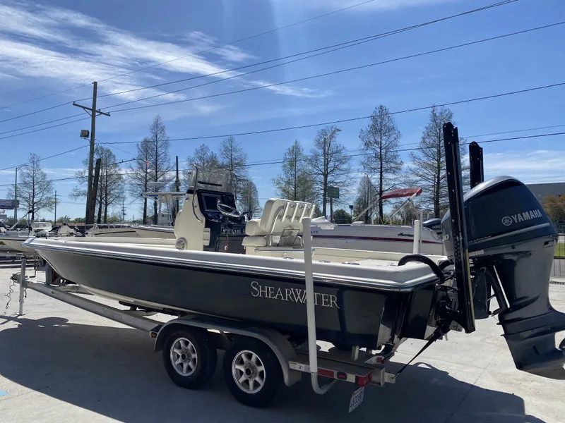 Slide: The Image of 2013 ShearWater 25LTZ boat on trailer with Yamaha engine, parked outdoors. - 17