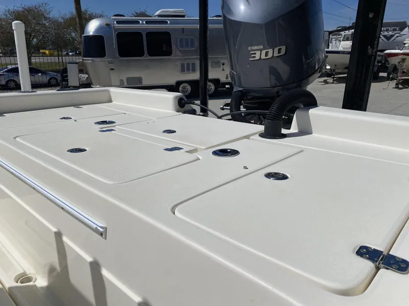 Slide: The Image of 2013 ShearWater 25LTZ boat with Yamaha 300 engine, parked near an Airstream trailer. - 21