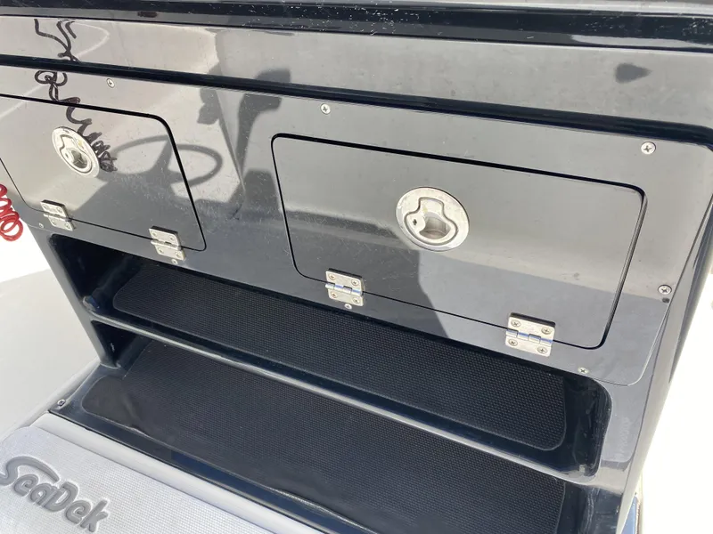 Slide: The Image of ShearWater 25LTZ 2013 boat storage compartments with SeaDek flooring. - 22