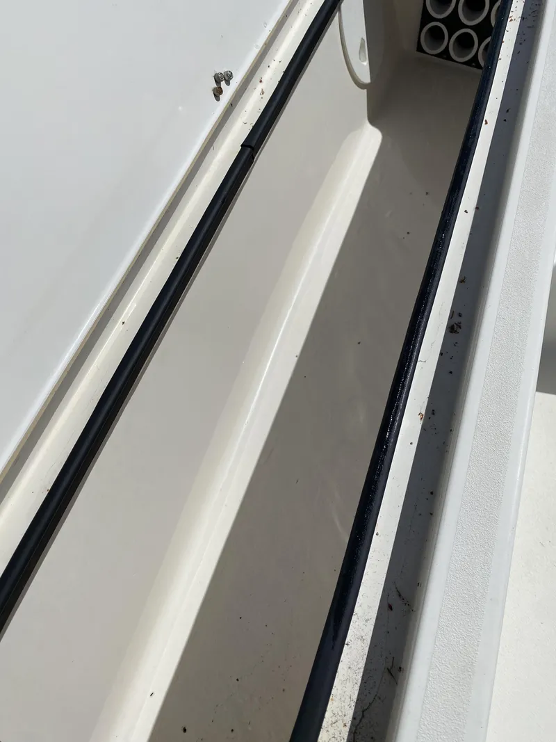 Slide: The Image of Open storage compartment on 2013 ShearWater 25LTZ boat. - 24