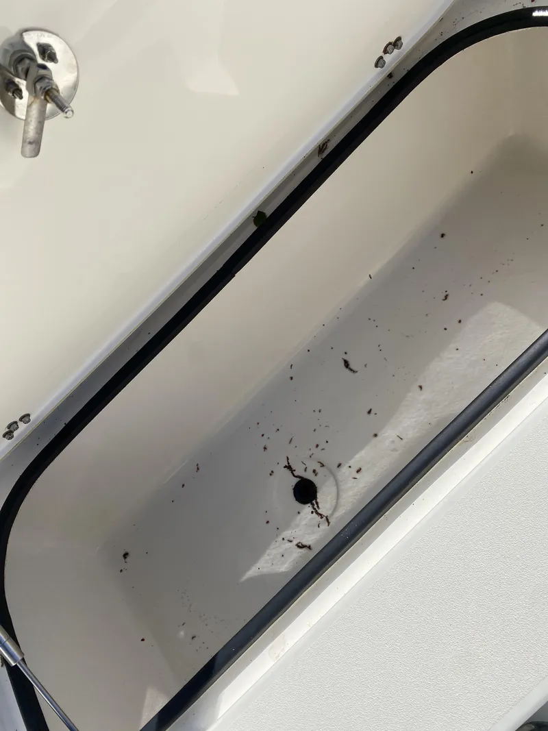 Slide: The Image of Open storage compartment on 2013 ShearWater 25LTZ boat, showing interior details. - 25