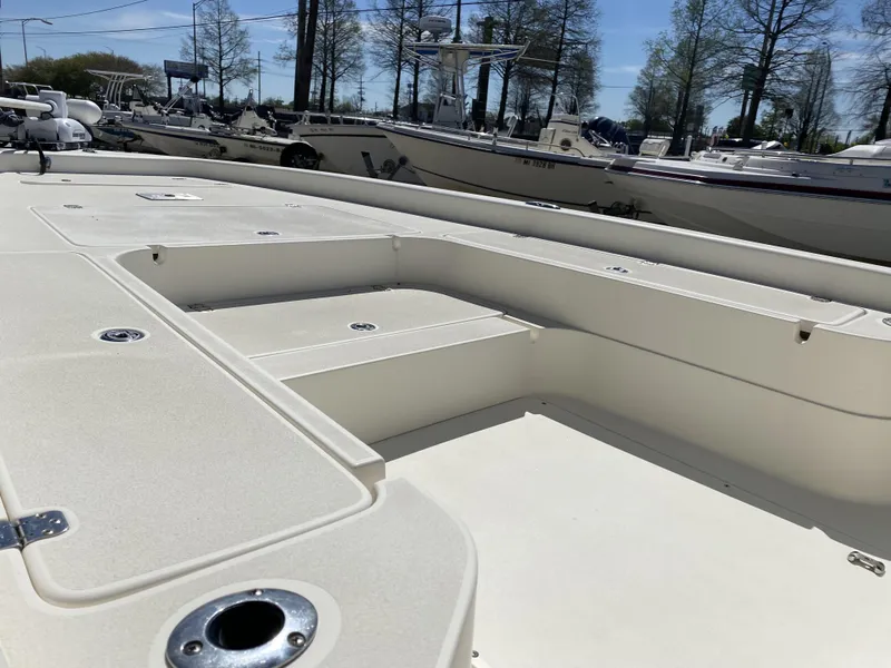 Slide: The Image of 2013 ShearWater 25LTZ boat deck with storage compartments and rod holders. - 5