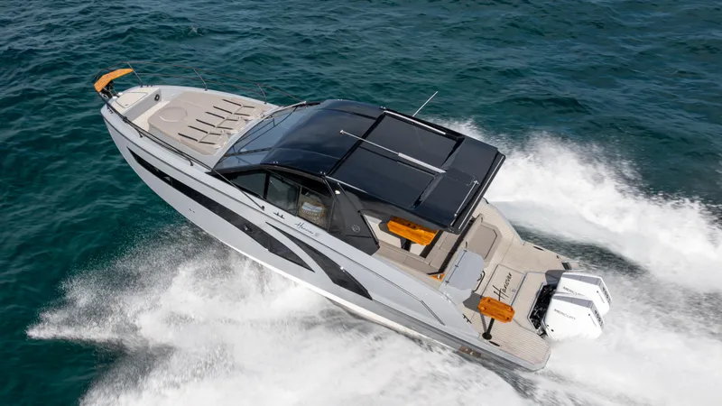 Slide: The Image of 2025 Hanover 387 Outboard boat cruising on open water. - 1