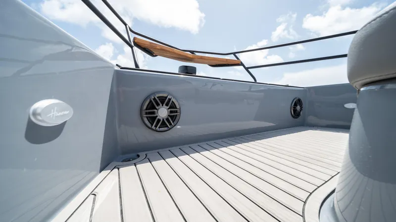 Slide: The Image of 2025 Hanover 387 Outboard boat deck with speakers and sleek design. - 11