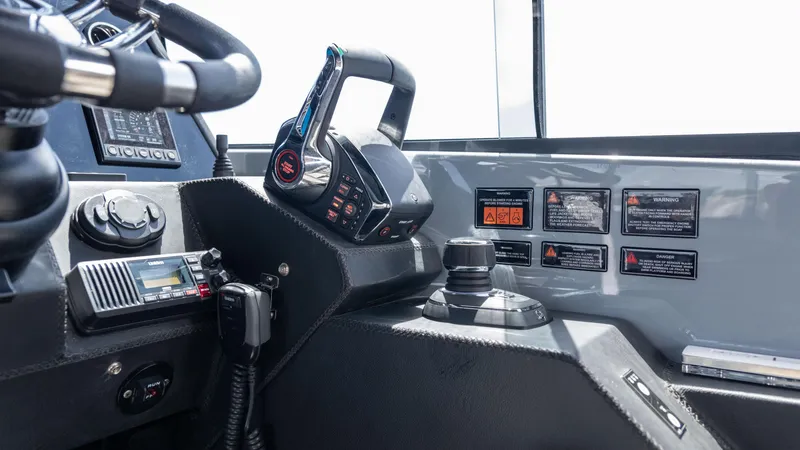 Slide: The Image of 2025 Hanover 387 Outboard boat cockpit with modern controls and navigation equipment. - 12