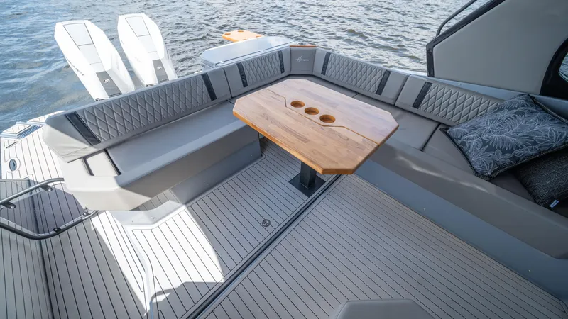 Slide: The Image of Luxurious seating area on 2025 Hanover 387 Outboard boat with wooden table. - 19