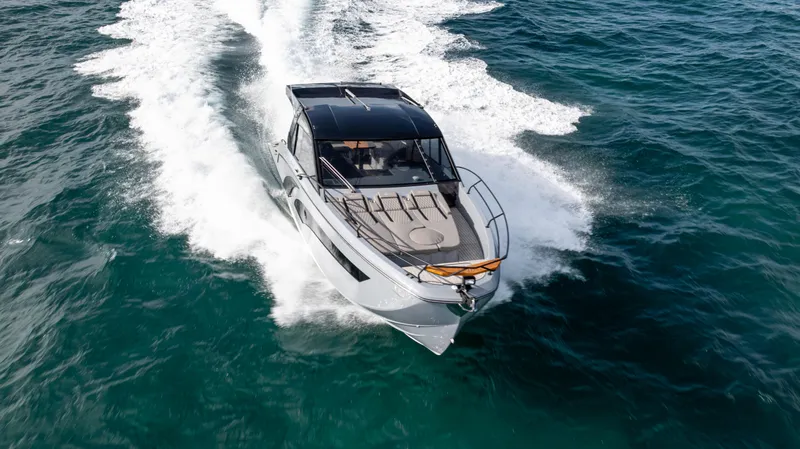 Slide: The Image of 2025 Hanover 387 Outboard cruising on open water, showcasing sleek design and powerful performance. - 2