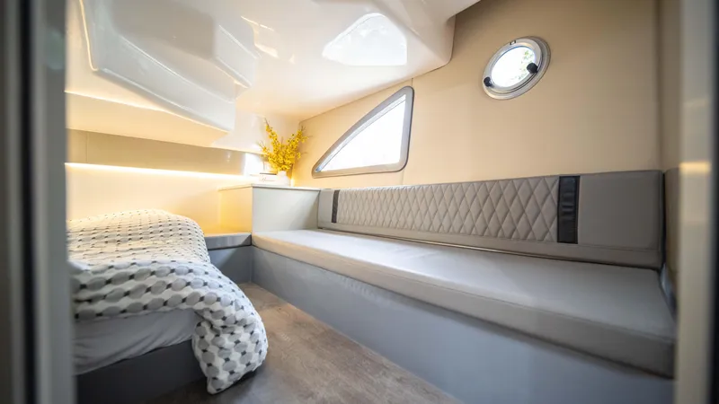 Slide: The Image of Luxurious interior of 2025 Hanover 387 Outboard boat with modern seating and bedding. - 32