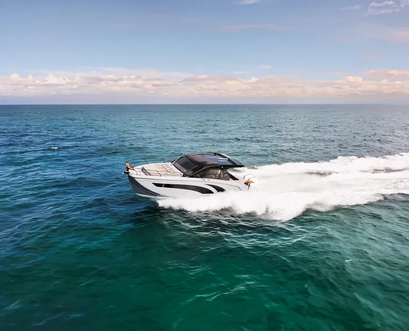 Slide: The Image of 2025 Hanover 387 Outboard cruising on open ocean under clear skies. - 8