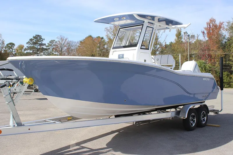Slide: The Image of 2025 Sea Fox 248 Commander boat on trailer, blue hull, outdoor setting. - 0