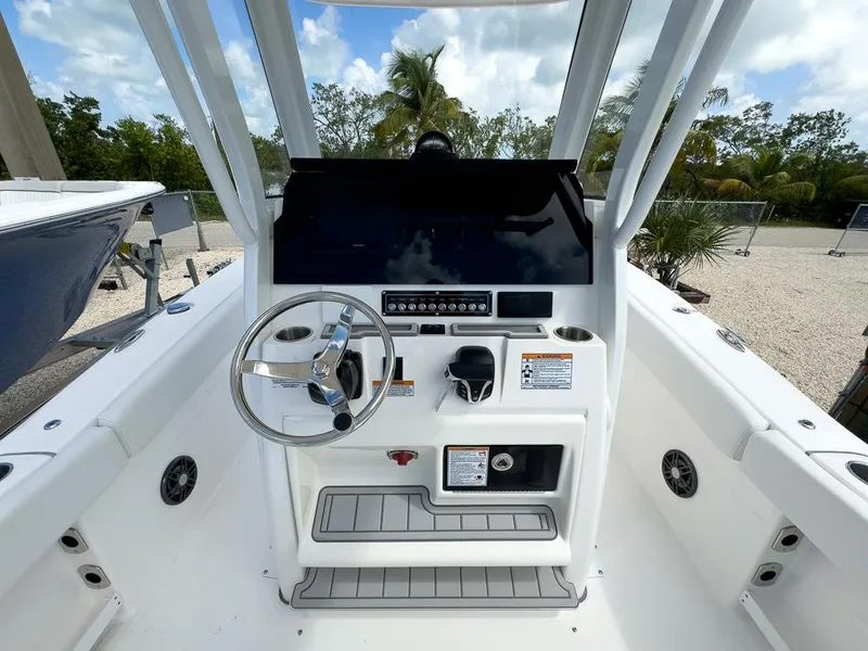 Slide: The Image of 2025 Sea Fox 248 Commander boat helm with steering wheel and control panel. - 10