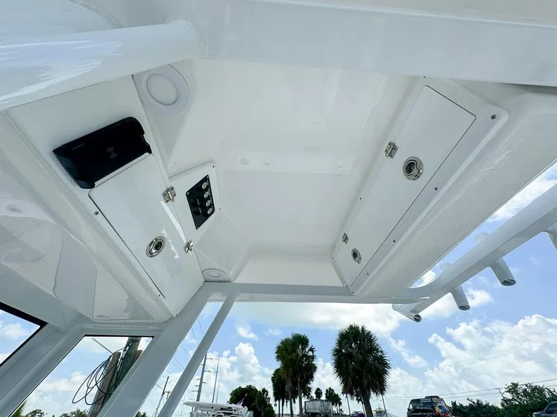 Slide: The Image of 2025 Sea Fox 248 Commander boat interior with storage compartments and clear sky view. - 13