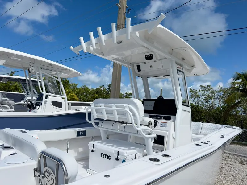 Slide: The Image of 2025 Sea Fox 248 Commander boat with T-top and seating, under a clear blue sky. - 4