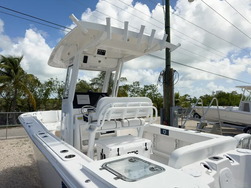 Slide: The Image of 2025 Sea Fox 248 Commander boat with center console and T-top, parked outdoors. - 5