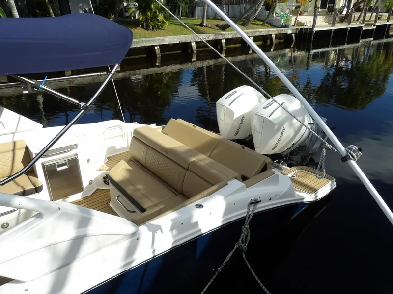 Slide: The Image of 2022 Sea Ray SDX 290 Outboard with twin engines docked by a canal. - 10