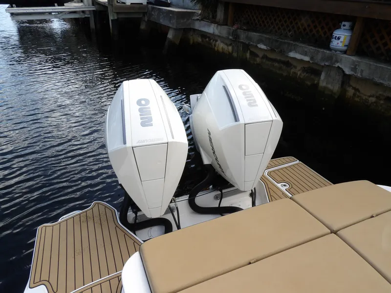 Slide: The Image of 2022 Sea Ray SDX 290 Outboard with twin engines on a wooden deck. - 12