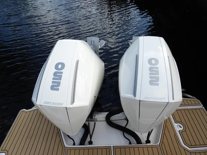 Slide: The Image of 2022 Sea Ray SDX 290 Outboard with twin Mercury engines on water. - 13