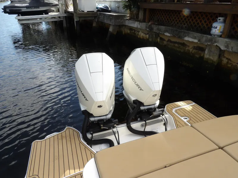 Slide: The Image of 2022 Sea Ray SDX 290 Outboard with twin engines docked by the water. - 14