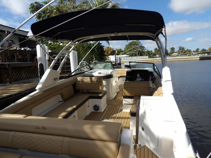 Slide: The Image of 2022 Sea Ray SDX 290 Outboard boat with spacious seating and canopy on a sunny day. - 17