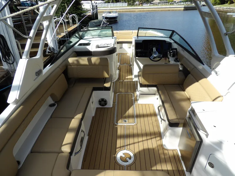 Slide: The Image of 2022 Sea Ray SDX 290 Outboard boat interior with tan seating and wood flooring. - 18