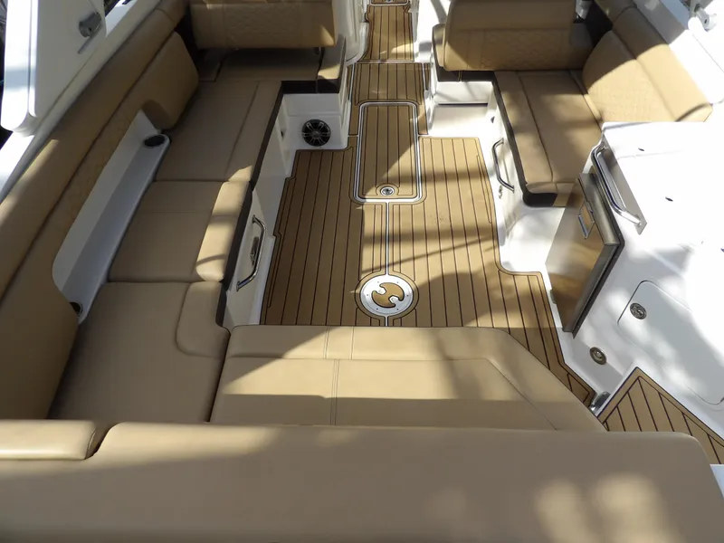 Slide: The Image of Luxurious interior of 2022 Sea Ray SDX 290 Outboard with tan seating and wood flooring. - 19