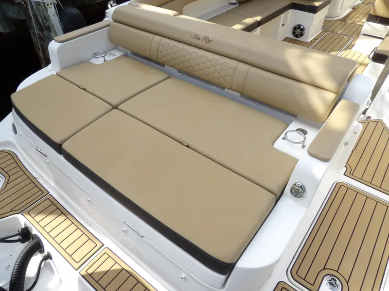Slide: The Image of 2022 Sea Ray SDX 290 Outboard boat with tan cushioned seating and teak-style flooring. - 20