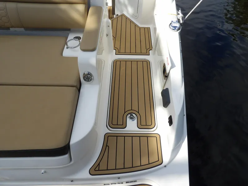 Slide: The Image of 2022 Sea Ray SDX 290 Outboard deck with tan seating and wood-style flooring. - 21