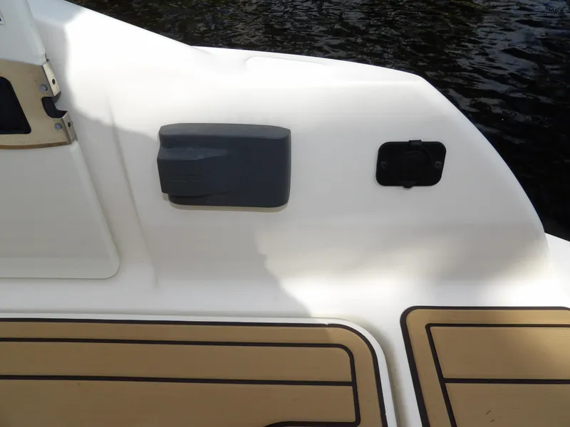 Slide: The Image of 2022 Sea Ray SDX 290 Outboard boat deck with water in the background. - 22