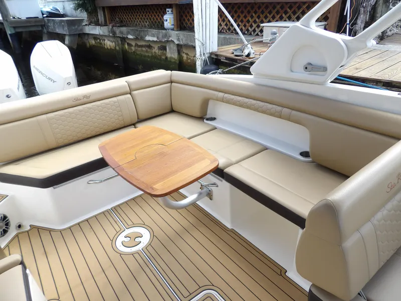 Slide: The Image of Luxurious seating area on 2022 Sea Ray SDX 290 Outboard boat with wooden table. - 28