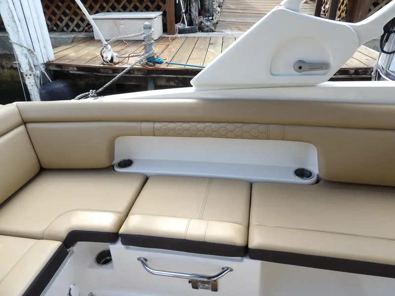 Slide: The Image of 2022 Sea Ray SDX 290 Outboard boat interior with beige seating and cup holders. - 29