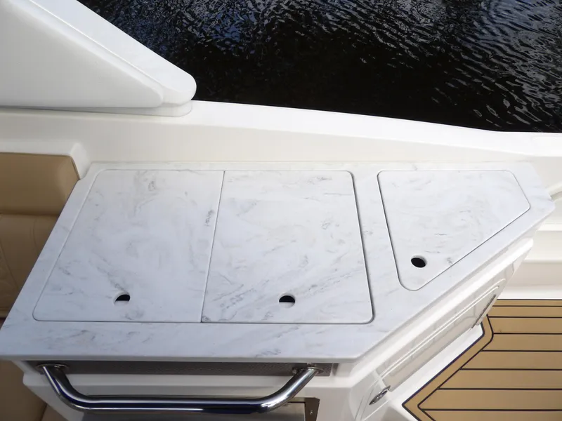 Slide: The Image of 2022 Sea Ray SDX 290 Outboard boat deck with marble countertop detail. - 32