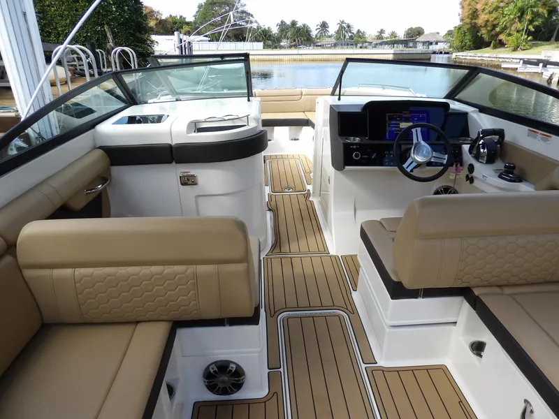 Slide: The Image of 2022 Sea Ray SDX 290 Outboard interior with tan seating and modern dashboard. - 34