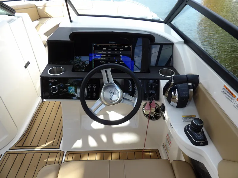 Slide: The Image of 2022 Sea Ray SDX 290 Outboard helm with modern controls and navigation display. - 36