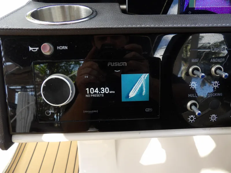 Slide: The Image of Control panel of 2022 Sea Ray SDX 290 Outboard with radio and navigation controls. - 38