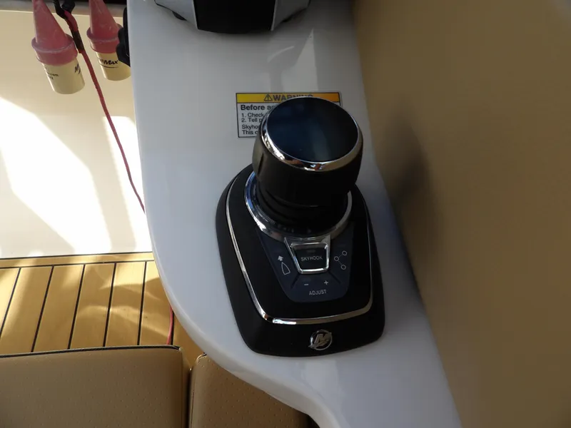 Slide: The Image of 2022 Sea Ray SDX 290 Outboard joystick control on beige interior. - 40