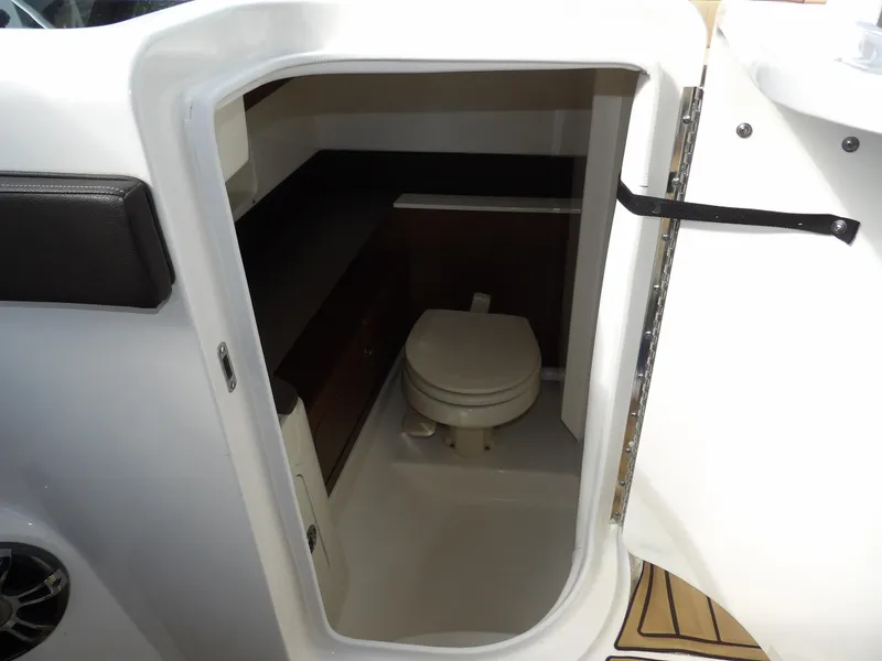 Slide: The Image of 2022 Sea Ray SDX 290 Outboard boat interior bathroom with toilet and storage. - 43
