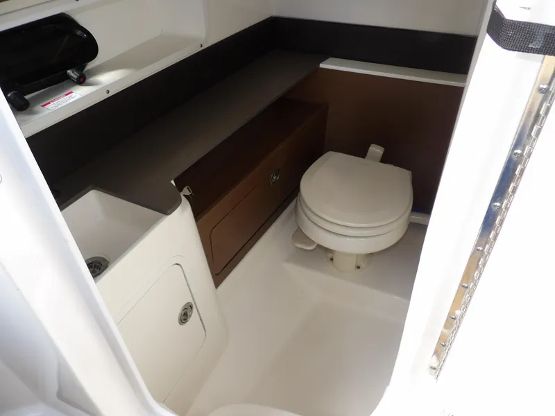 Slide: The Image of 2022 Sea Ray SDX 290 Outboard boat bathroom with sink and toilet. - 44