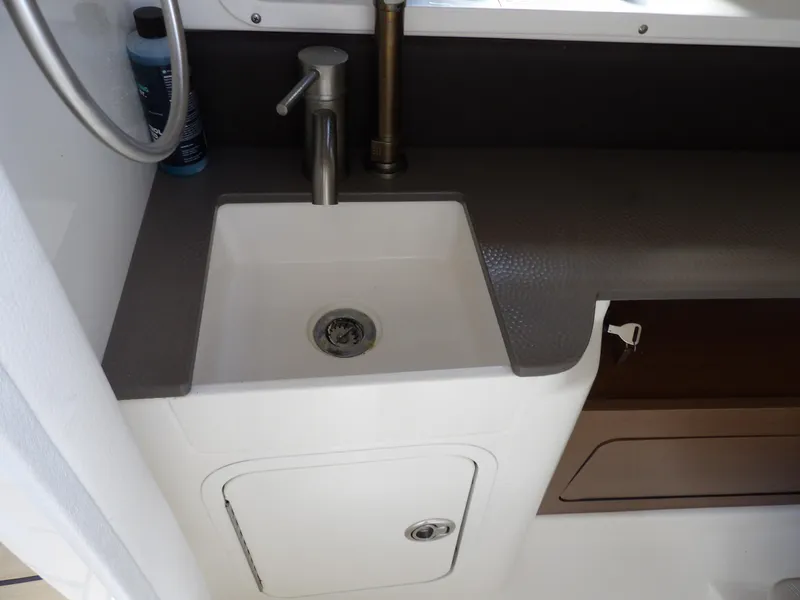 Slide: The Image of 2022 Sea Ray SDX 290 Outboard boat sink with faucet and storage compartment. - 45
