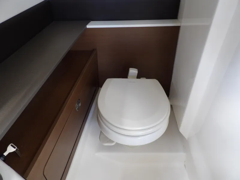 Slide: The Image of 2022 Sea Ray SDX 290 Outboard boat interior with compact marine toilet. - 46