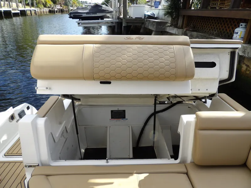 Slide: The Image of 2022 Sea Ray SDX 290 Outboard boat interior with tan seating and storage compartments. - 47