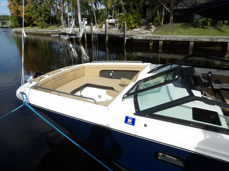 Slide: The Image of 2022 Sea Ray SDX 290 Outboard boat docked by a scenic waterfront. - 7